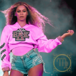 A photograph of Beyonce performing at Coachella, with a golden Virgo symbol on the lower right corner