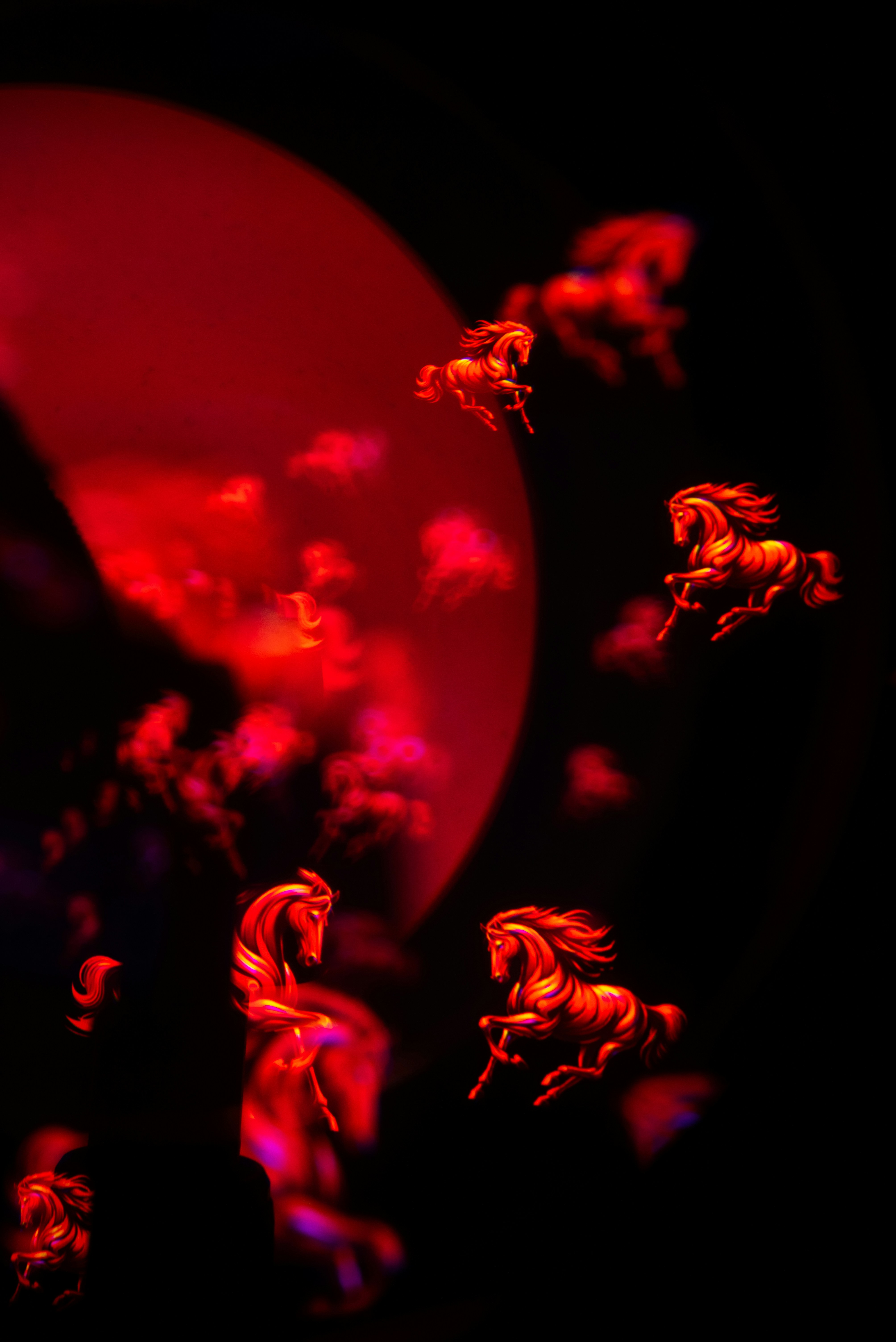 Illustration of fiery red horses in a dark, abstract background.